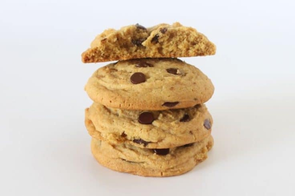 Stack of thick and chewy chocolate chip cookies with golden edges and gooey chocolate chips