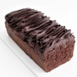 chocolate banana cake loaf topped with thick chocolate ganache