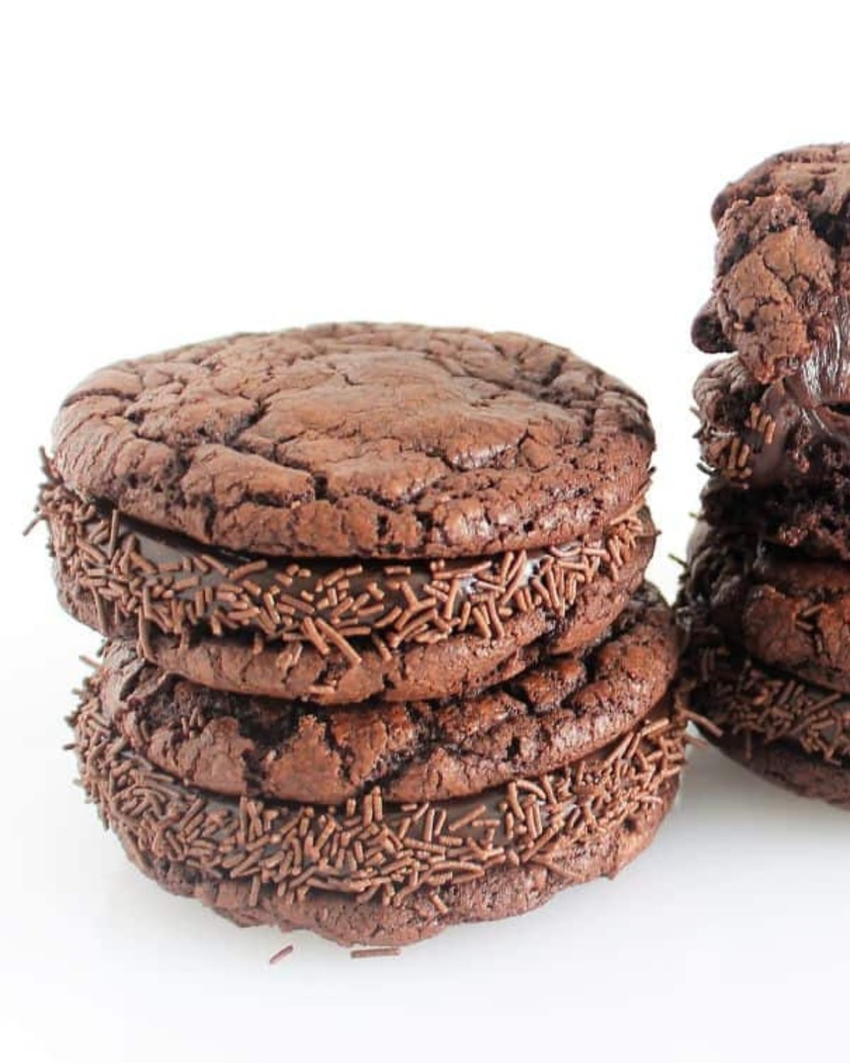 Stack of Brownie Cookie Sandwiches on a white serving plate ready to eat