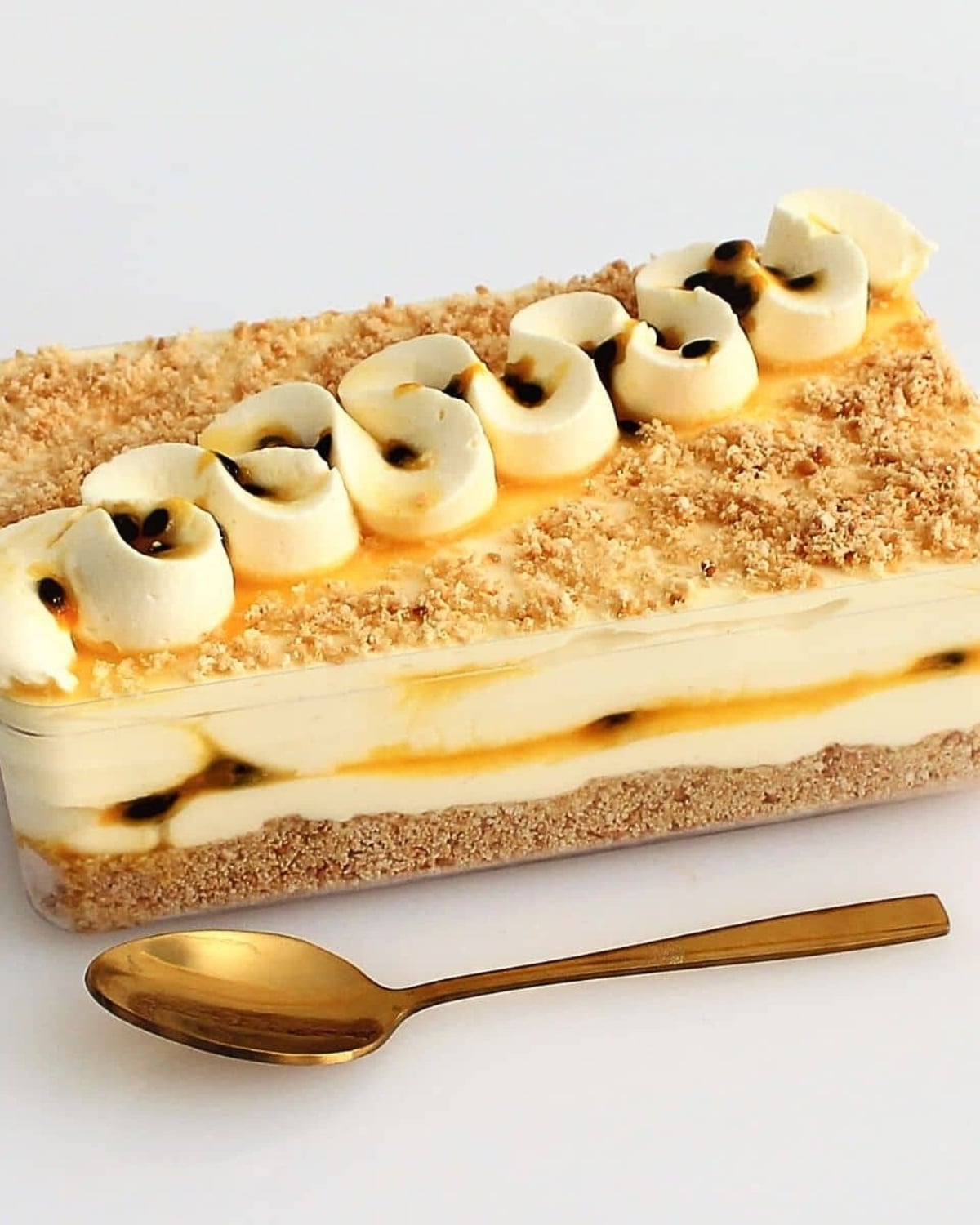 Creamy Passion Fruit Mousse dessert box layered with cookie crumbs, whipped cream, and fresh passionfruit pulp