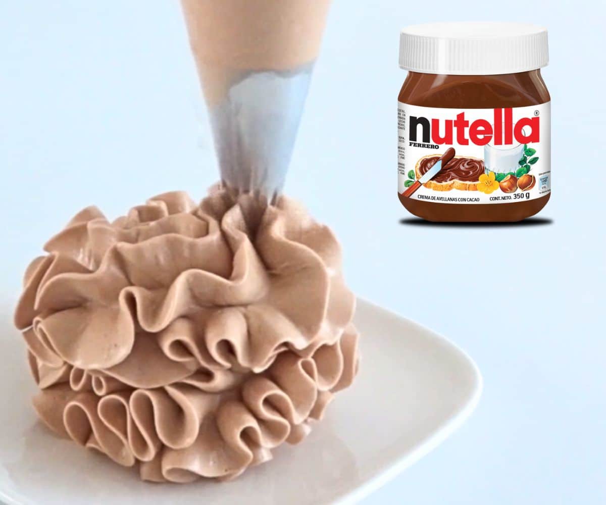 Piping tall ruffled swirls of Nutella buttercream with a jar of Nutella beside it