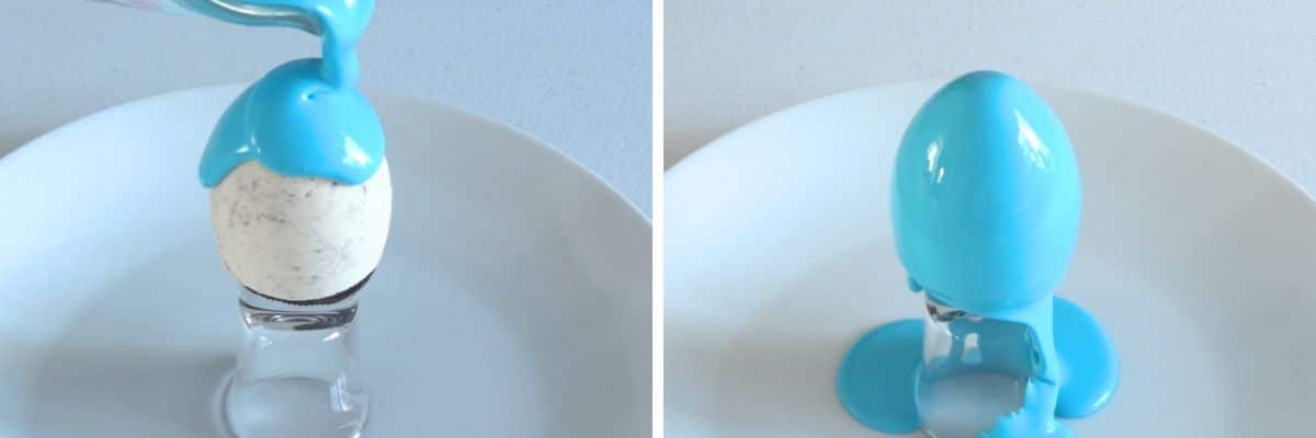 Pouring blue mirror glaze over frozen cheesecake egg