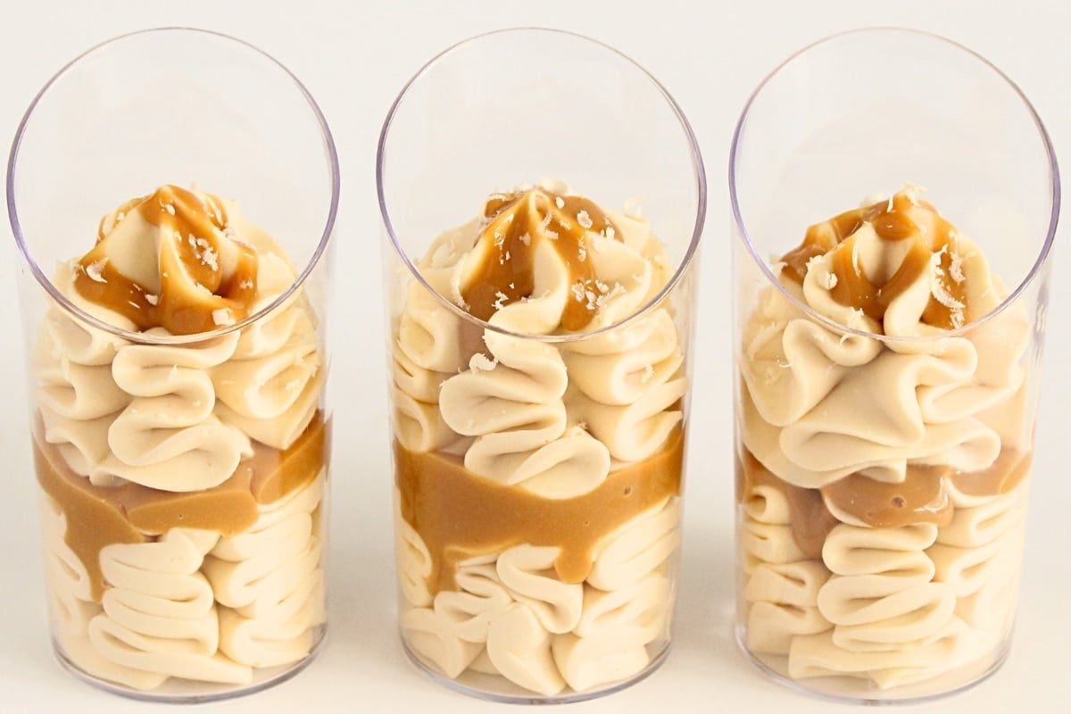 Overhead view of caramel mousse topped with grated white chocolate