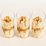 Caramel mousse piped into clear dessert cups with a caramel sauce layer