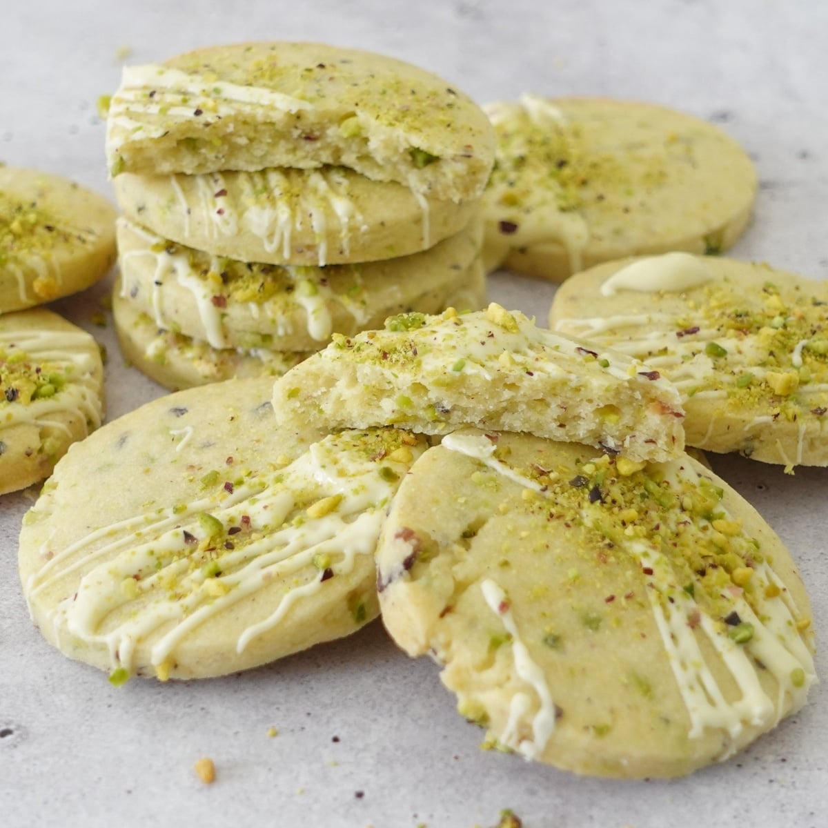 buttery pistachio shortbread cookies with white chocolate drizzle