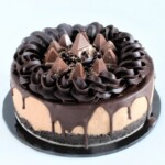 Whole Toblerone cheesecake with chocolate drip, ganache border, and Toblerone pieces on top