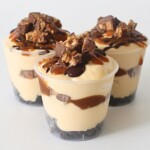 Close up of layered Snickers Dessert Cup showing chocolate, caramel, and peanut layers