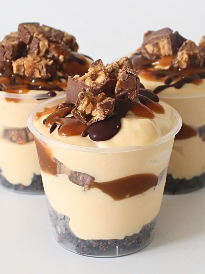 Close up of layered Snickers Dessert Cup showing chocolate, caramel, and peanut layers