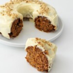 Moist carrot cake recipe decorated with cream cheese frosting and walnuts.
