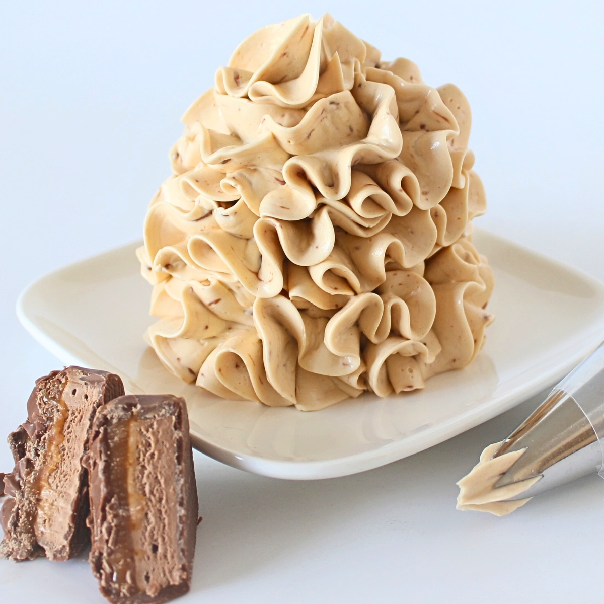 Close-up of Mars Bar Buttercream piped in a tall swirl with a star tip