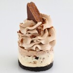 Tim Tam Mini Cheesecakes with whipped cream and biscuit crumbs on top