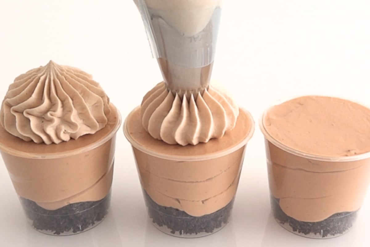 Whipped cream piped on top of chocolate mousse cups