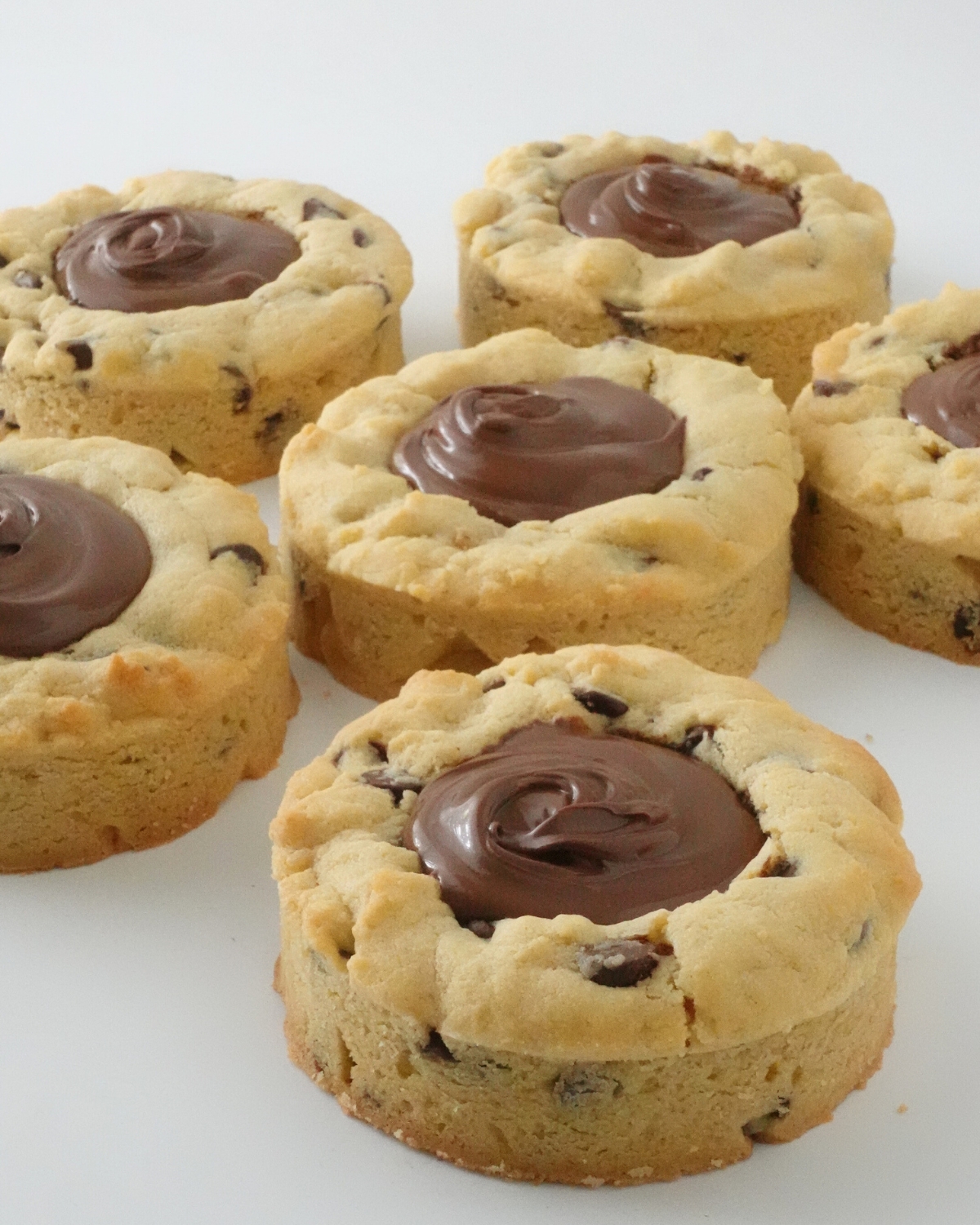 Thick Nutella deep dish cookies filled with creamy Nutella and baked in tart rings