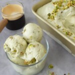 Bowl of creamy pistachio ice cream with chopped pistachios beside a loaf pan filled with ice cream and an espresso shot for affogato