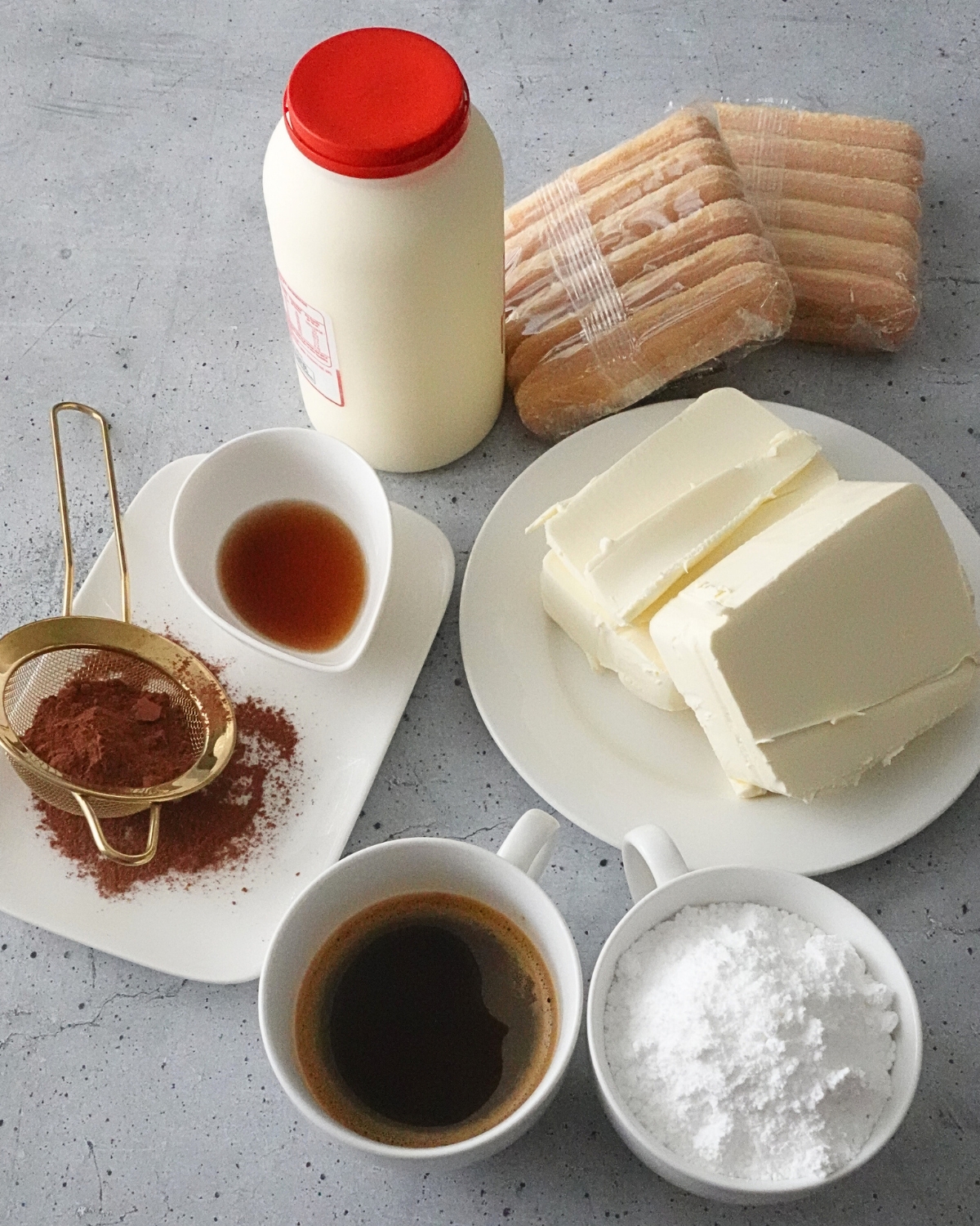 tiramisu cheesecake ingredients including cream cheese powdered sugar coffee sponge fingers vanilla and thickened cream