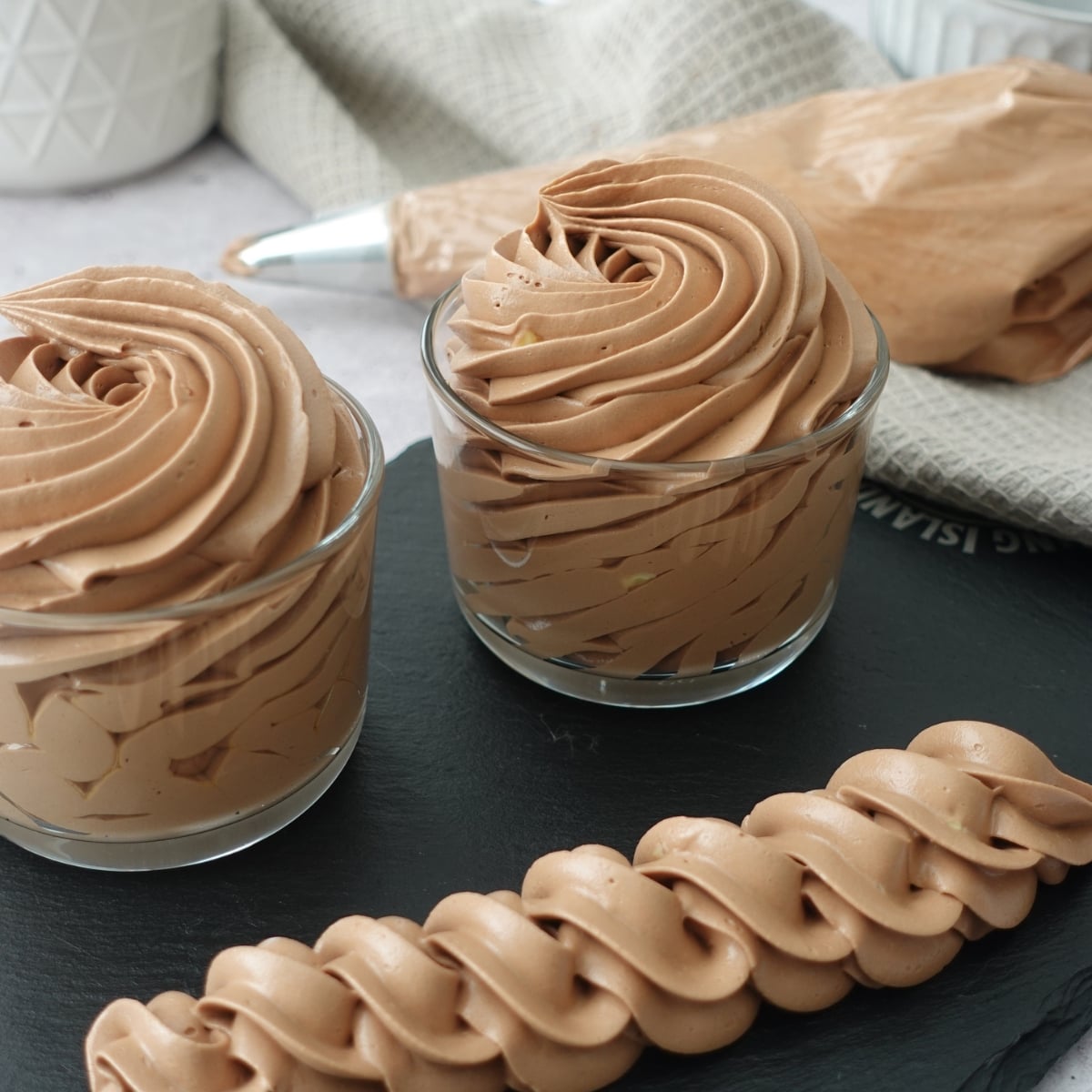 Piped chocolate hot water buttercream swirls and rope border, silky and no grit