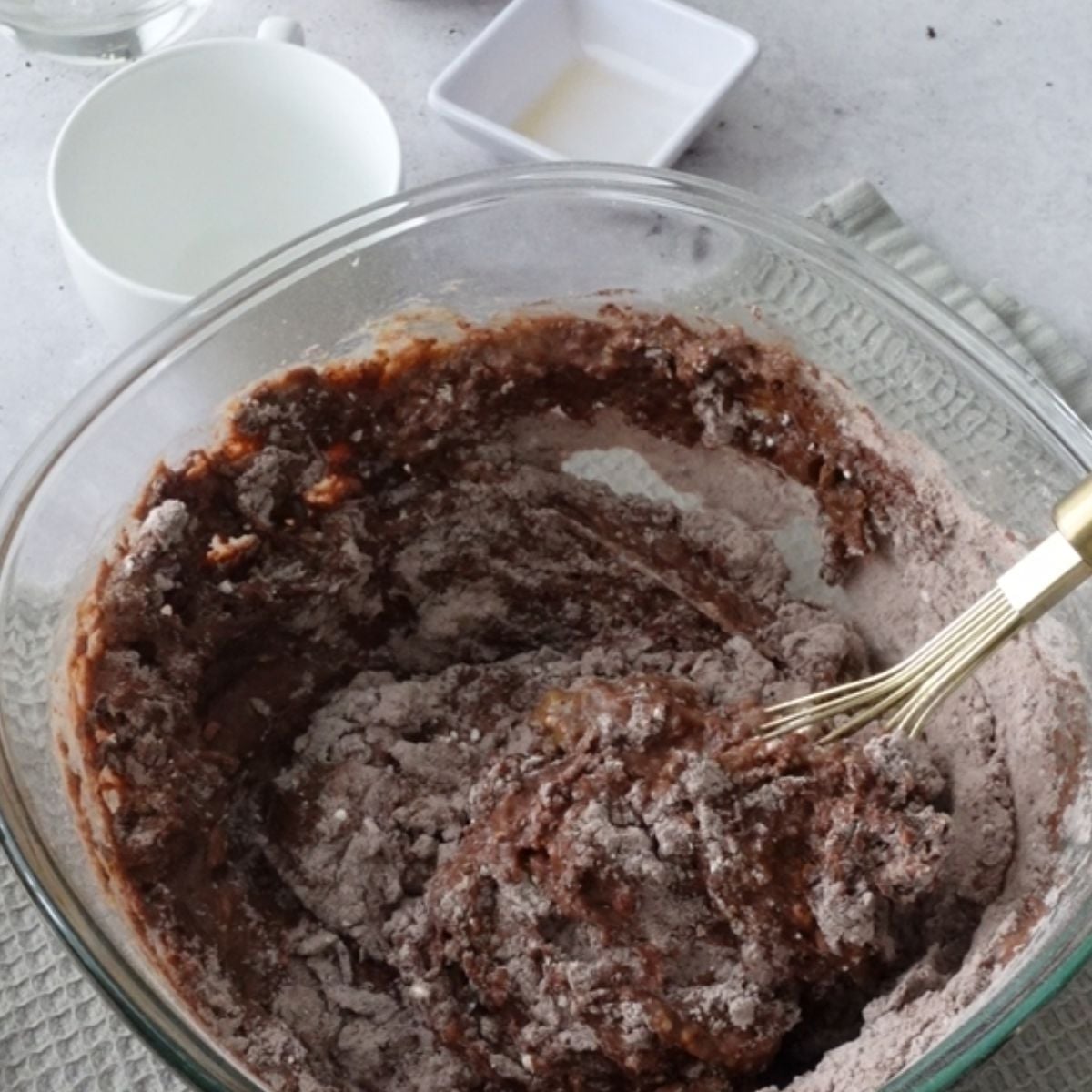 Wet ingredients being mixed into dry ingredients for chocolate pudding batter