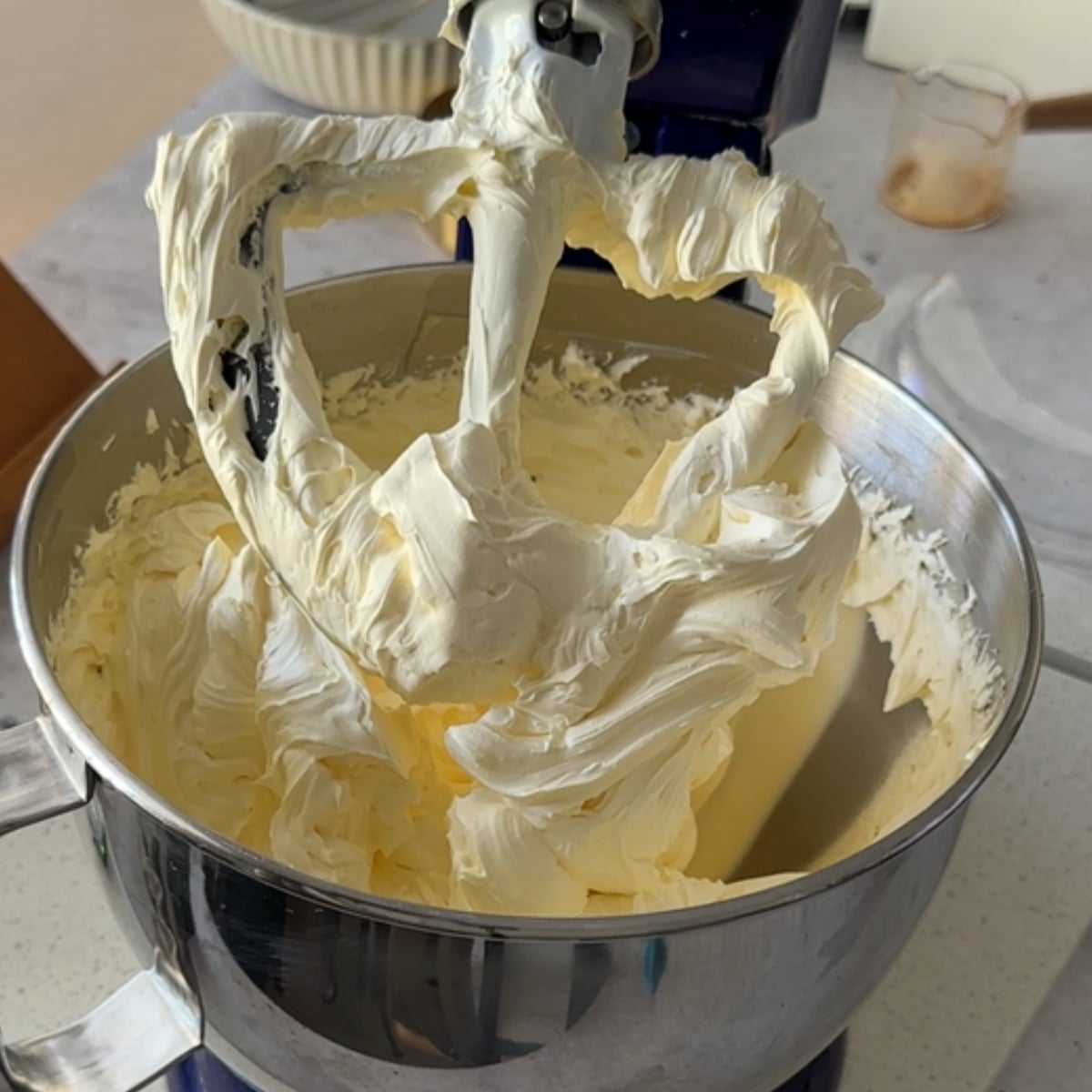 Butter whipped light and fluffy in a stand mixer for coffee hot water buttercream