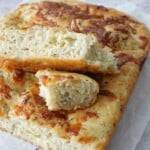 Same-day herb and cheese focaccia sliced open showing cheesy interior