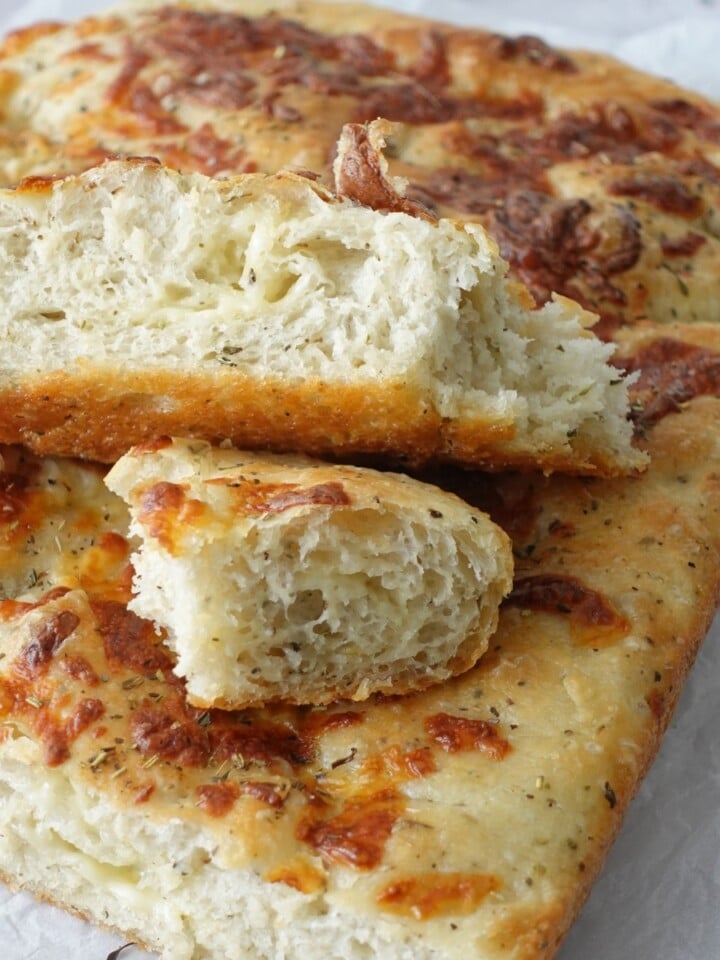 Same-day herb and cheese focaccia sliced open showing cheesy interior