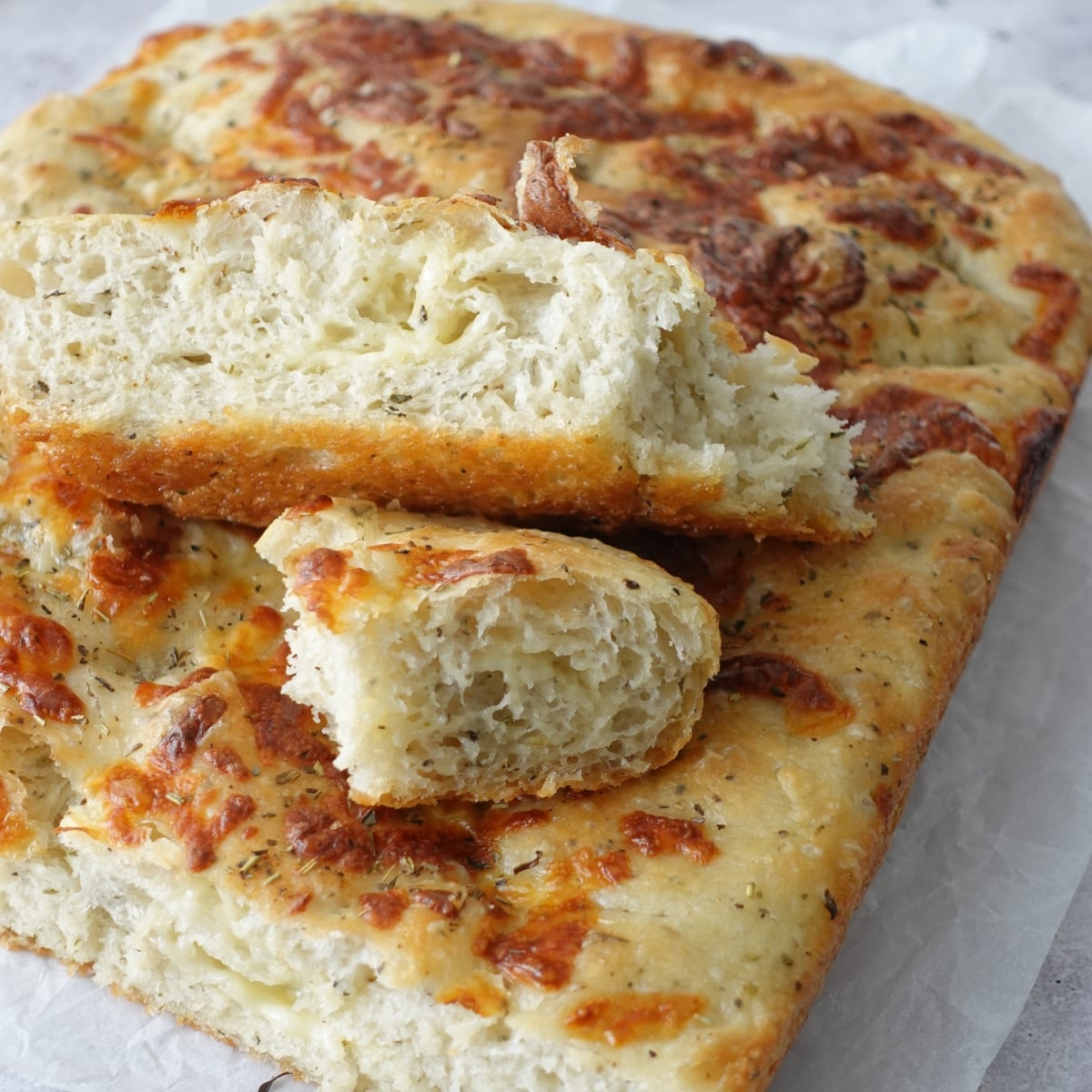 Same-day herb and cheese focaccia sliced open showing cheesy interior