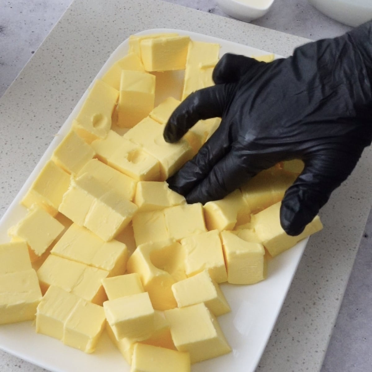 Butter cut into cubes on a tray ready for mixing