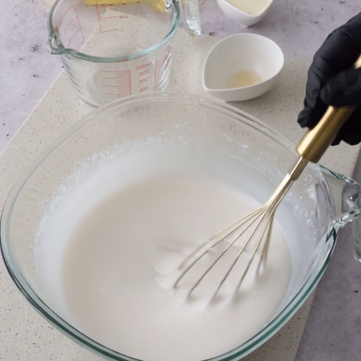 Powdered sugar fully dissolved in hot water and vanilla, whisked smooth in a glass bowl
