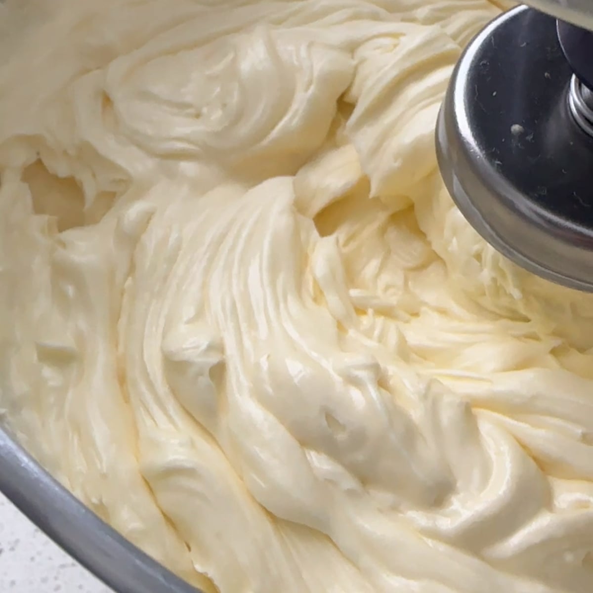 Finished hot water buttercream, smooth and glossy in a stand mixer bowl