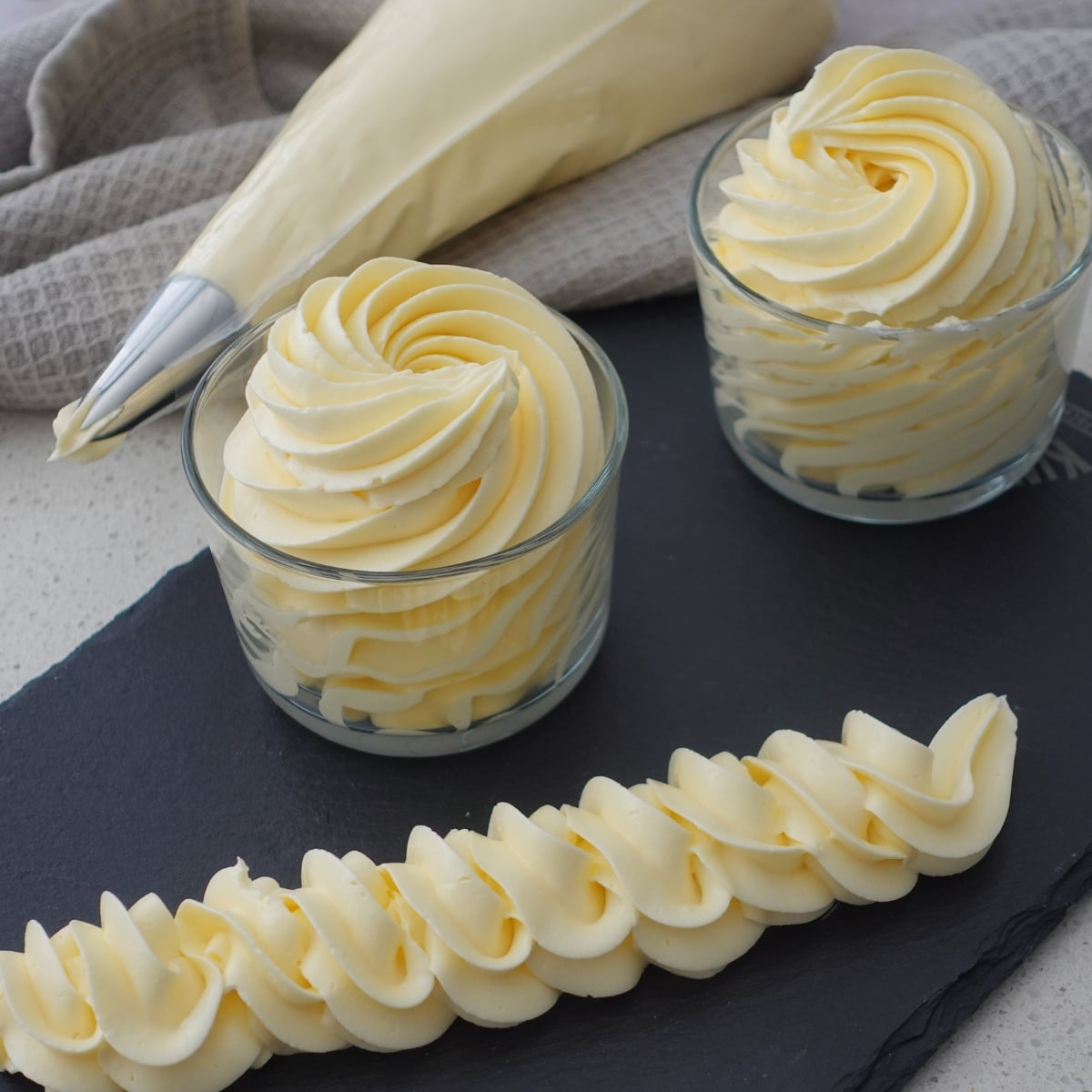 Piped hot water buttercream swirls and rope border, smooth and no grit texture