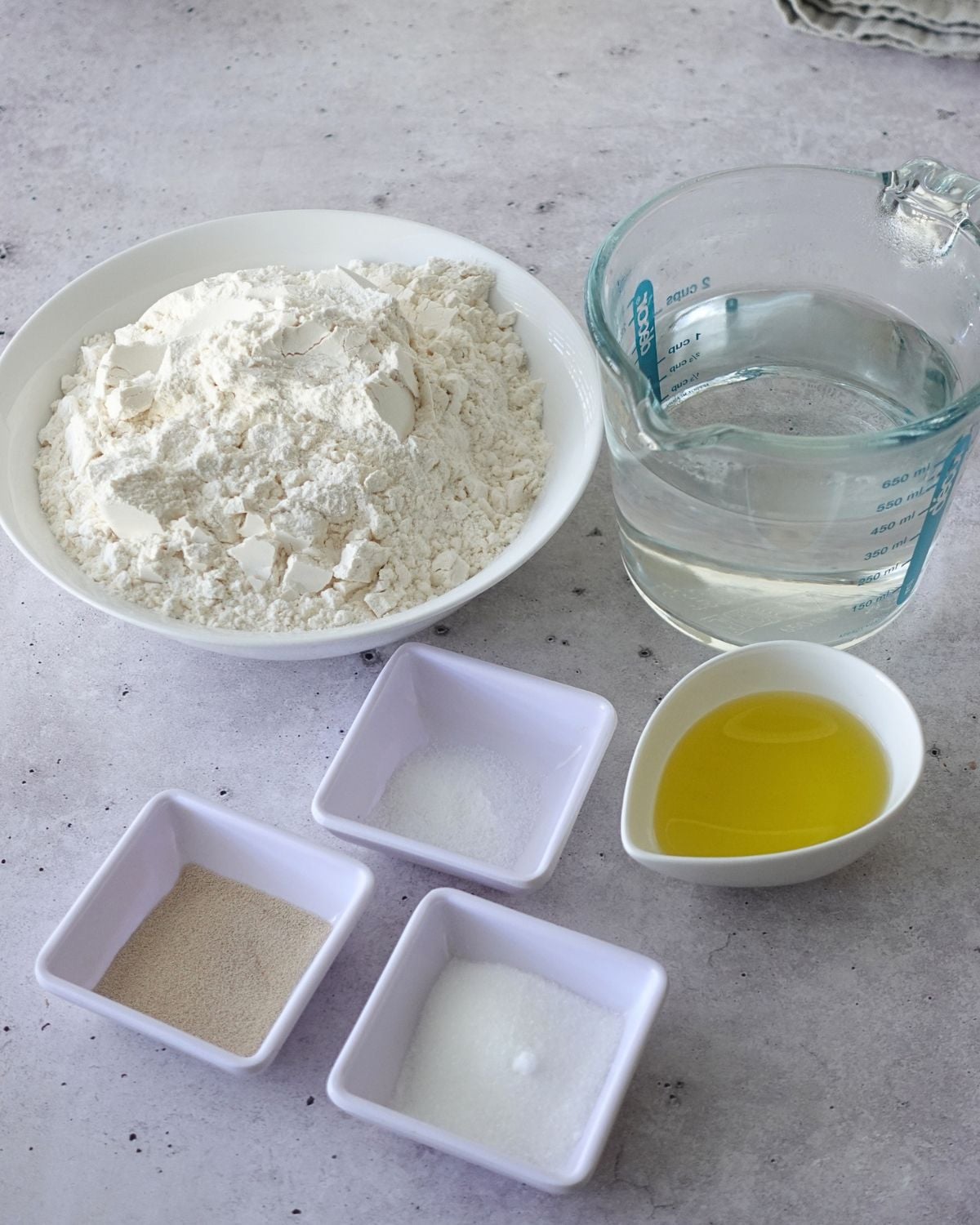 Shredded mozzarella cheese and dried Italian herbs for focaccia topping