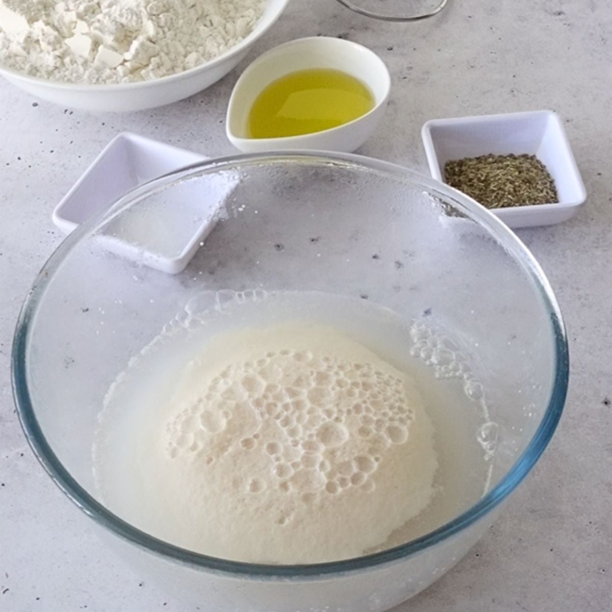 Foamy activated yeast mixture in a large bowl
