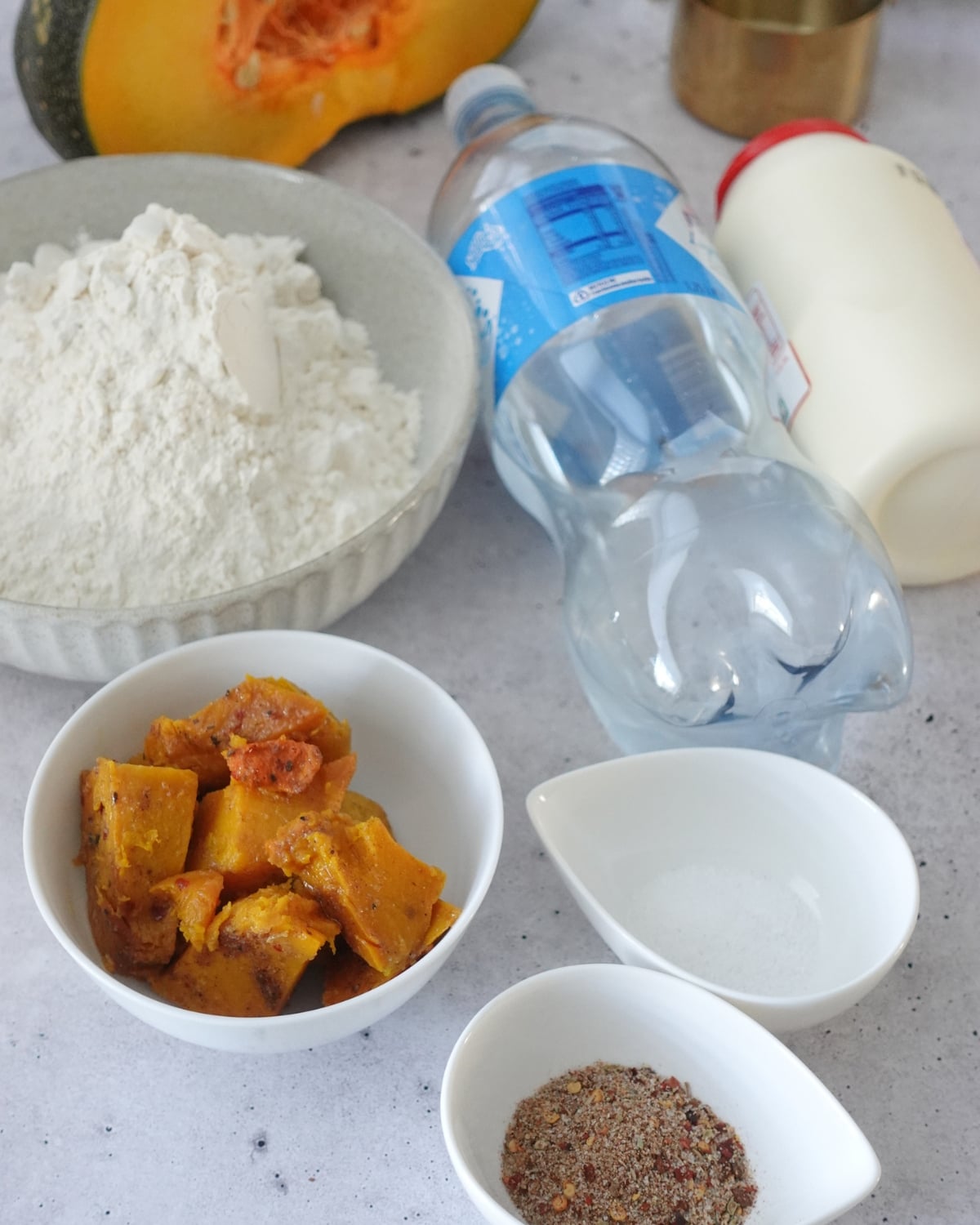 Ingredients for peri peri pumpkin scones including flour, roast pumpkin, cream, sparkling water and peri peri spice blend
