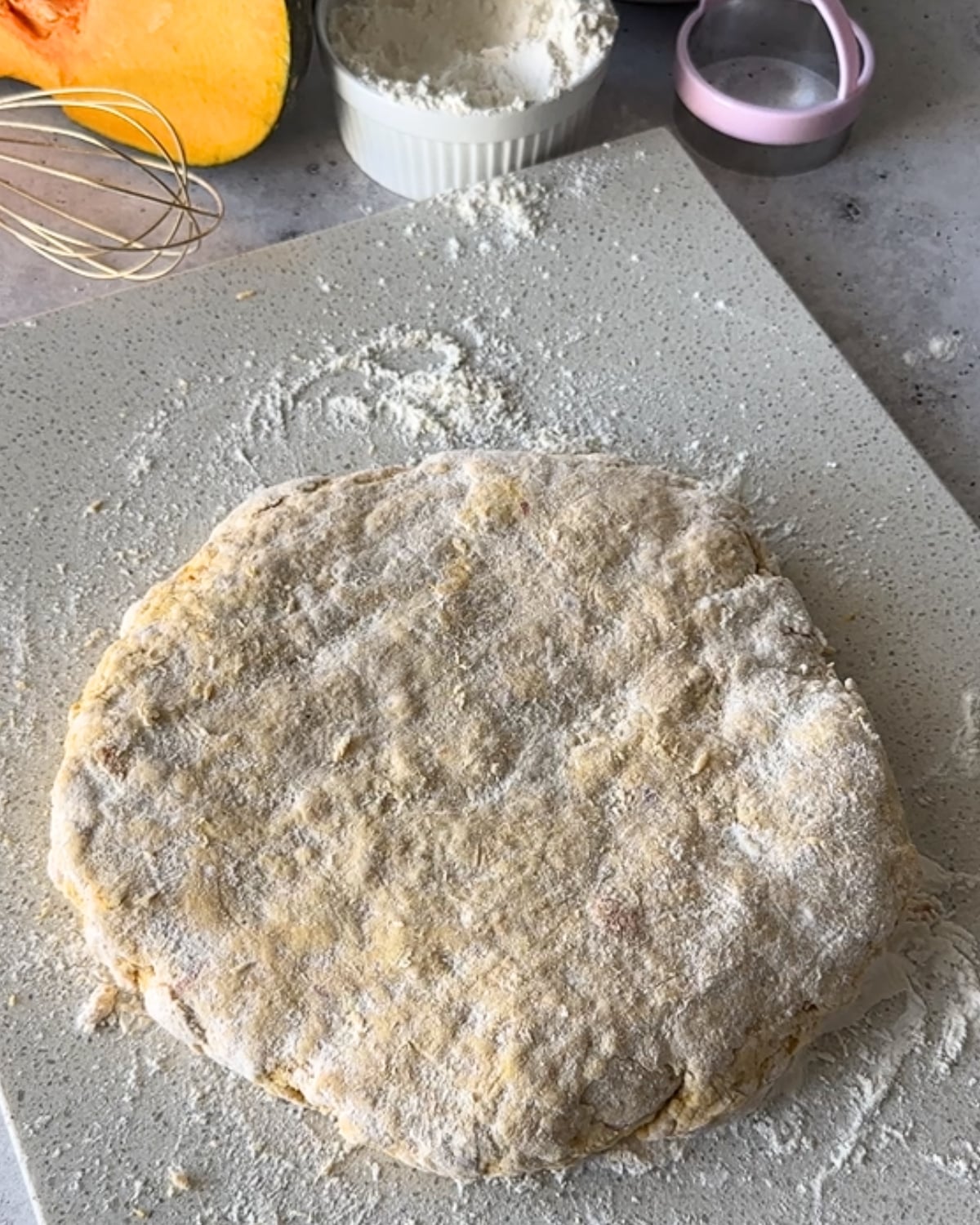 Peri peri pumpkin scone dough patted into a circle on a floured board