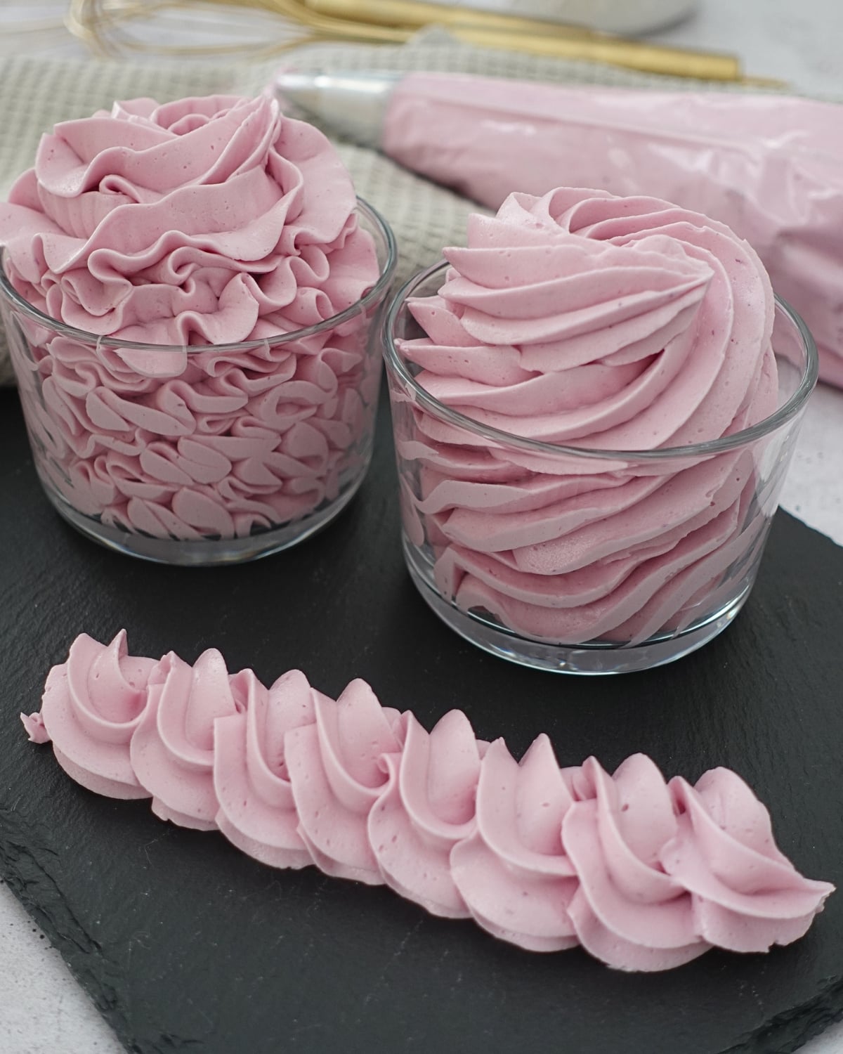 Ube hot water buttercream piped into swirls with a rope border, smooth and no grit texture