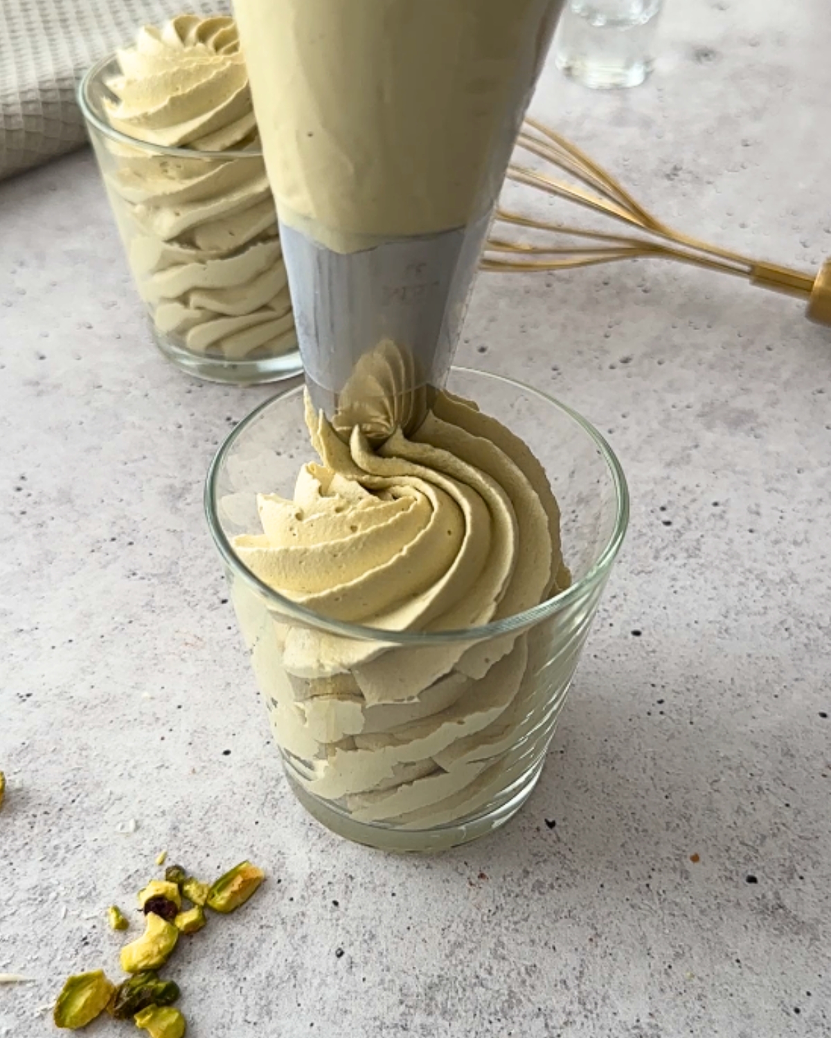 Pistachio mousse piped into a small glass with a Jem 3J piping tip